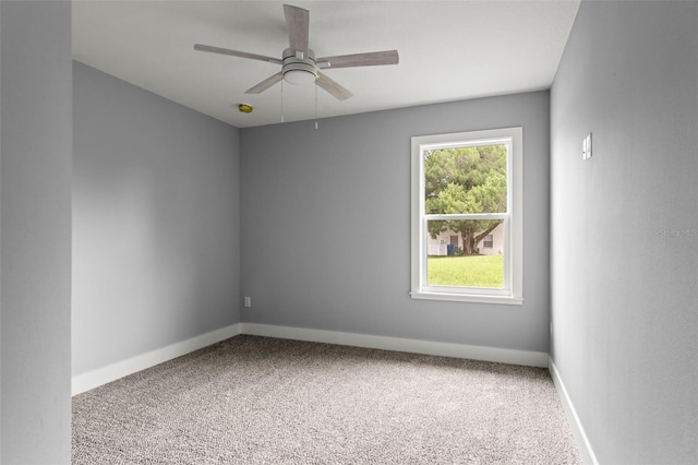 spare room featuring carpet and ceiling fan