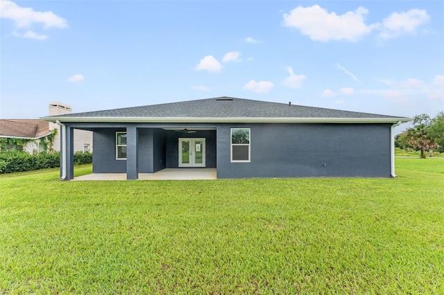 rear view of house with a lawn and a patio area