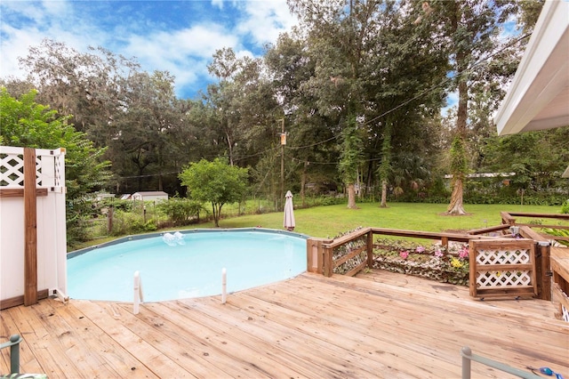 view of swimming pool with a wooden deck and a yard