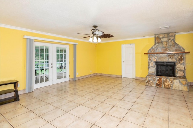 unfurnished living room with a textured ceiling, a fireplace, crown molding, ceiling fan, and french doors