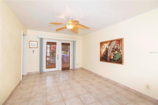 tiled spare room with a textured ceiling, ceiling fan, and french doors