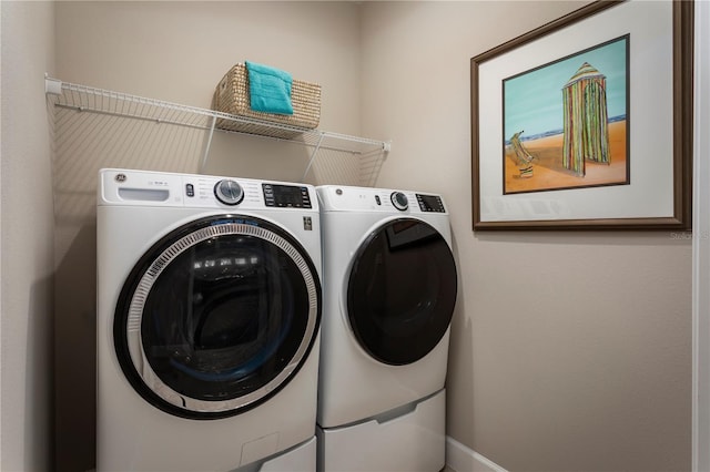 laundry room featuring washing machine and clothes dryer