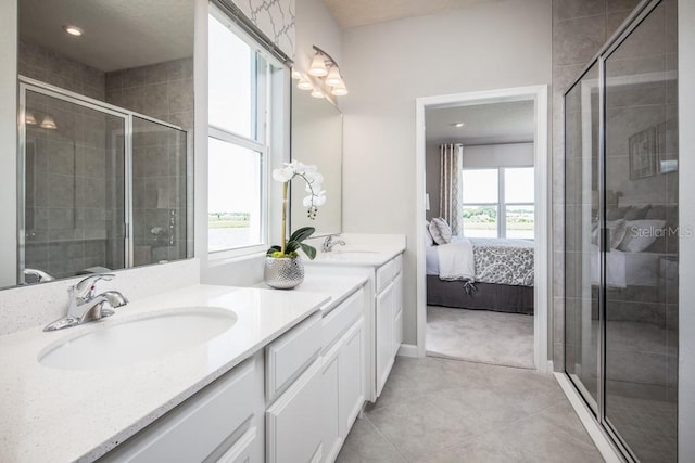 bathroom with tile patterned flooring, a shower with door, and vanity