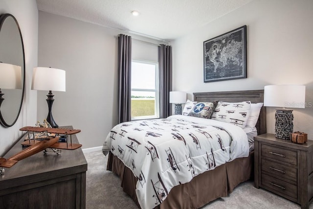 carpeted bedroom with a textured ceiling