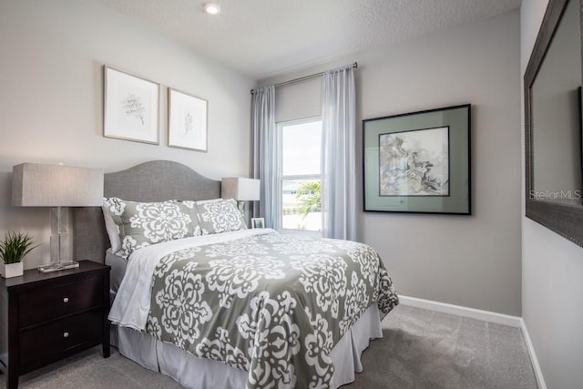 carpeted bedroom with a textured ceiling