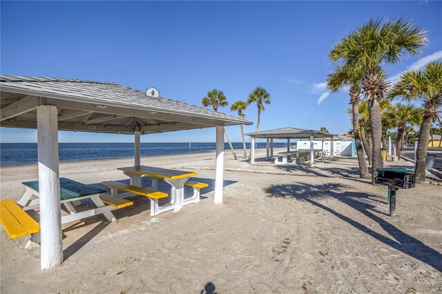 view of home's community with a water view, a beach view, and a gazebo