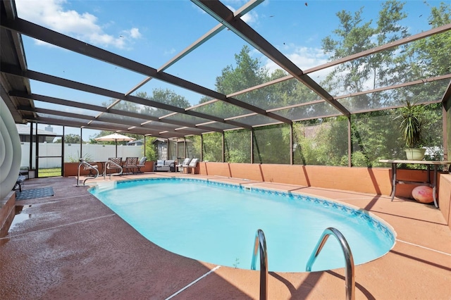 view of pool with glass enclosure and a patio