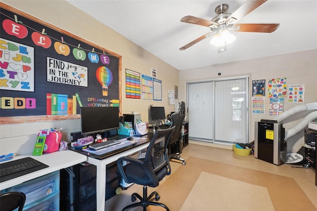 office area with a textured ceiling and ceiling fan