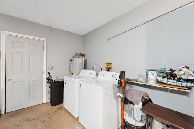 laundry area featuring electric water heater, a textured ceiling, and washing machine and clothes dryer