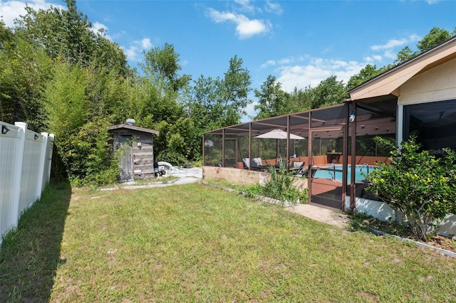 view of yard featuring glass enclosure and a fenced in pool