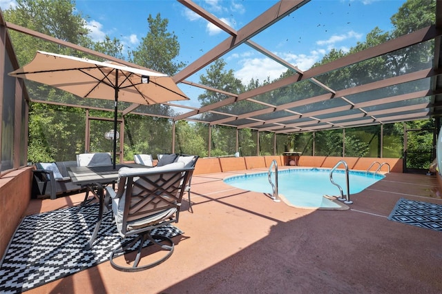 view of swimming pool with a patio and a lanai