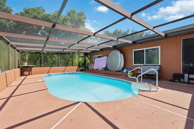 view of swimming pool with a lanai and a patio