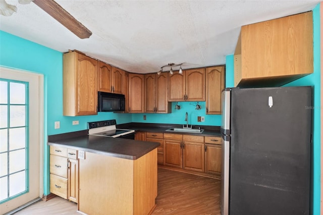 365 S Snapp Ave, Inverness, FL 34453 - kitchen with freestanding refrigerator, a sink, black microwave, electric stove, and dark countertops