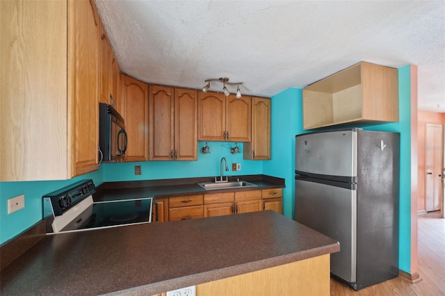365 S Snapp Ave, Inverness, FL 34453 - kitchen with freestanding refrigerator, stove, a sink, black microwave, and dark countertops