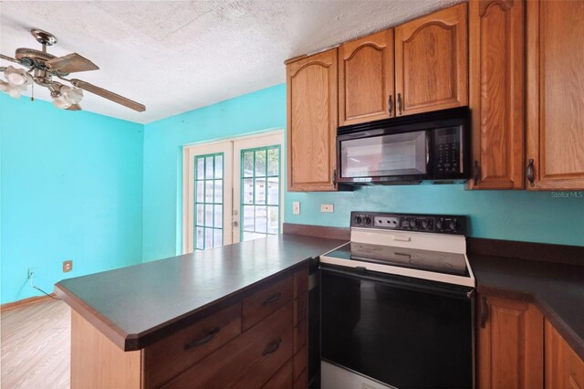365 S Snapp Ave, Inverness, FL 34453 - kitchen featuring a peninsula, dark countertops, range with electric cooktop, ceiling fan, and black microwave