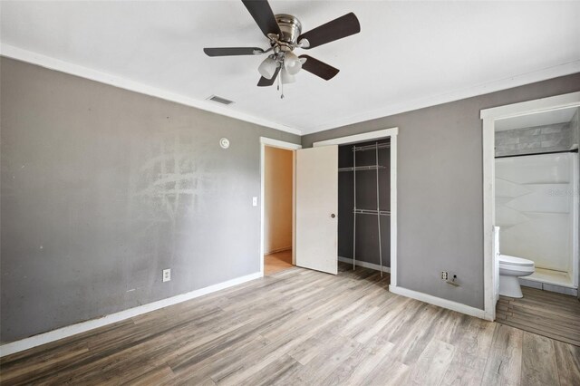 365 S Snapp Ave, Inverness, FL 34453 - unfurnished bedroom featuring a closet, wood finished floors, visible vents, crown molding, and baseboards