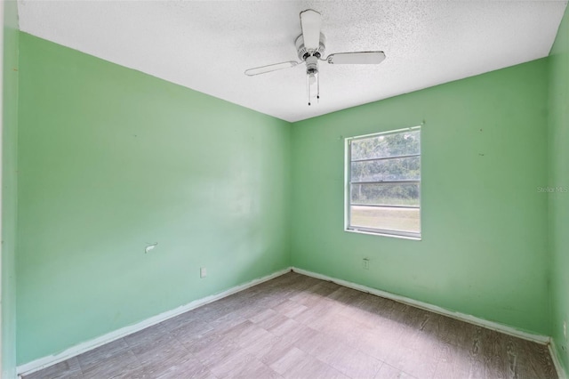 unfurnished room featuring a textured ceiling and ceiling fan