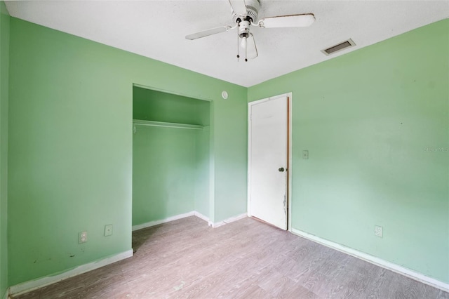 365 S Snapp Ave, Inverness, FL 34453 - unfurnished bedroom featuring a closet, visible vents, wood finished floors, and baseboards
