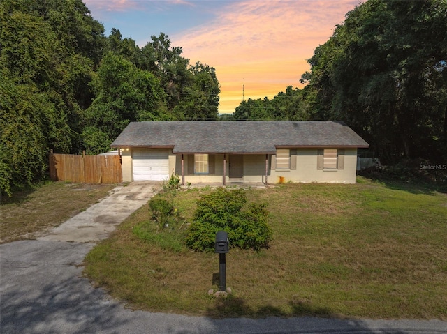365 S Snapp Ave, Inverness, FL 34453 - view of front of home with a porch, fence, an attached garage, concrete driveway, and a front yard