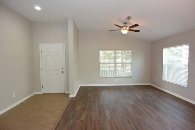 unfurnished room with vaulted ceiling, dark wood-type flooring, and ceiling fan