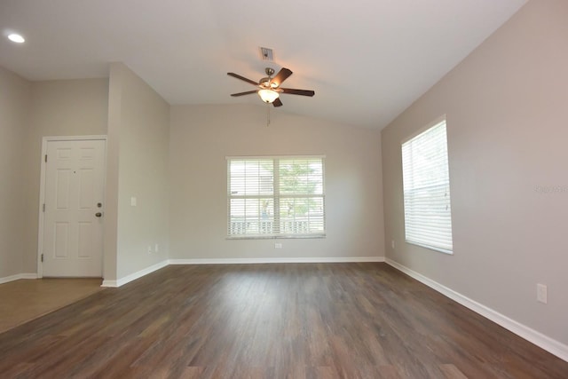 empty room with ceiling fan, dark hardwood / wood-style floors, and vaulted ceiling