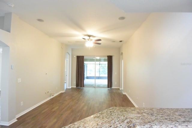 unfurnished room featuring dark hardwood / wood-style flooring and ceiling fan