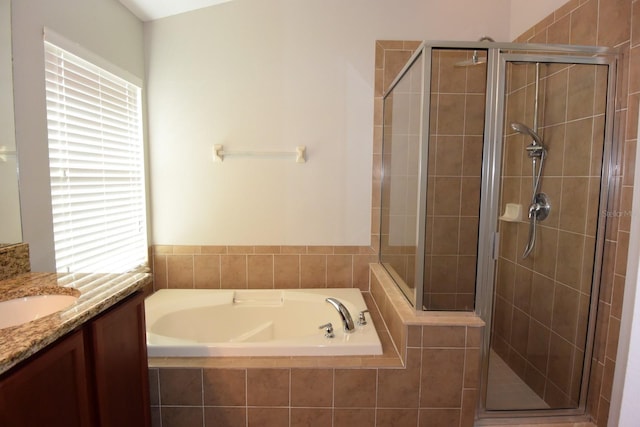 bathroom with vanity and separate shower and tub