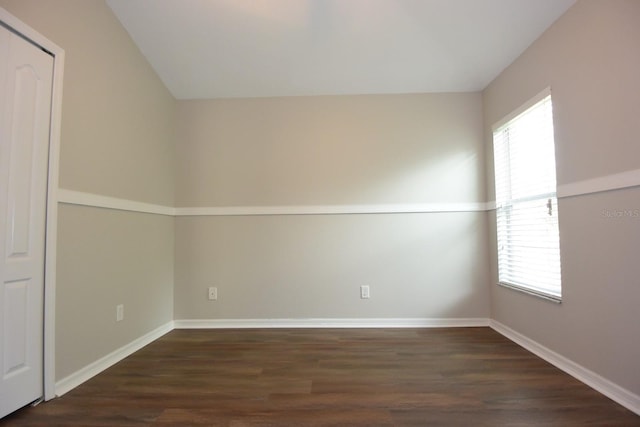 spare room with dark hardwood / wood-style floors and a wealth of natural light