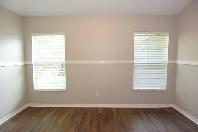 empty room featuring dark hardwood / wood-style floors and plenty of natural light