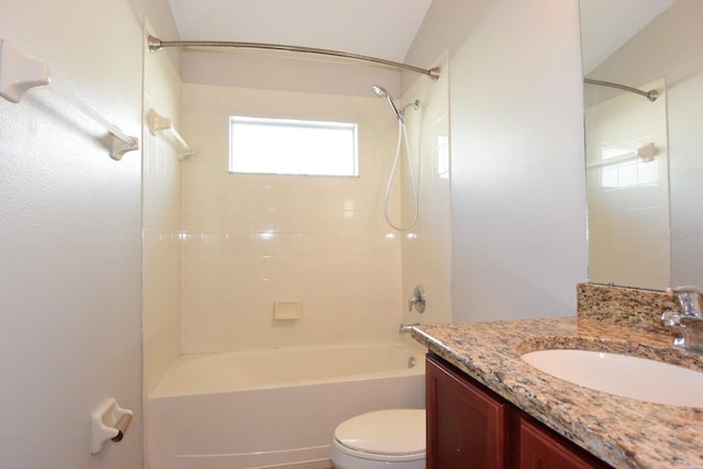 full bathroom with tiled shower / bath, vanity, and toilet