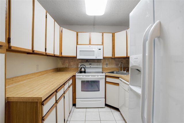 kitchen featuring white cabinets, white appliances, tasteful backsplash, and sink