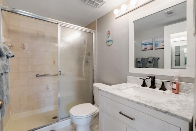 bathroom featuring vanity, toilet, tile patterned floors, and a shower with door