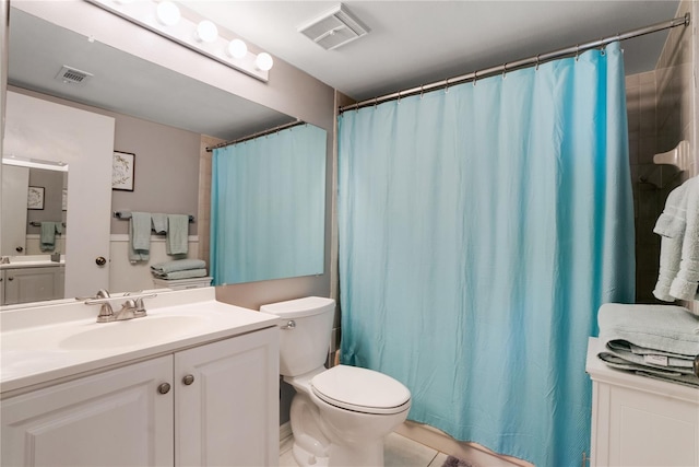 bathroom featuring tile patterned flooring, vanity, toilet, and a shower with shower curtain