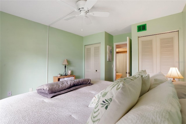 bedroom with multiple closets and ceiling fan