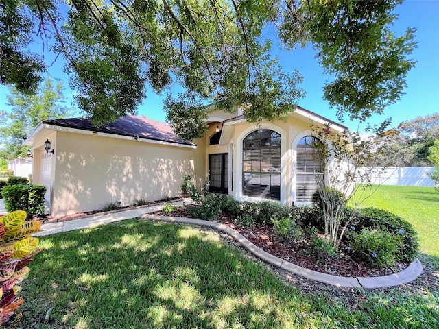 mediterranean / spanish-style house featuring a front lawn