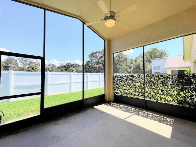 unfurnished sunroom with lofted ceiling and ceiling fan