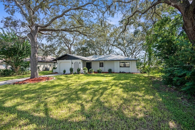 ranch-style home with a garage and a front lawn