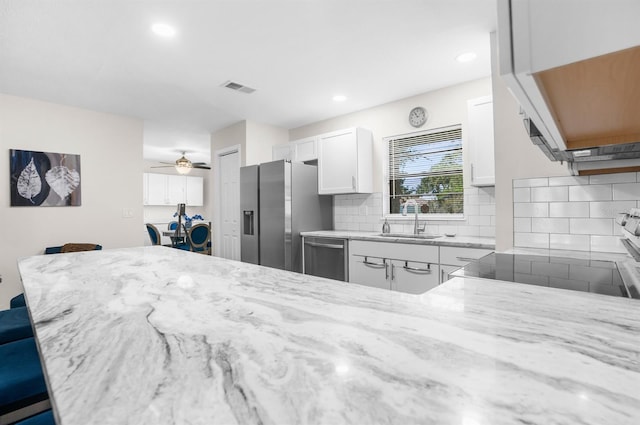 kitchen featuring ceiling fan, white cabinets, stainless steel appliances, and sink