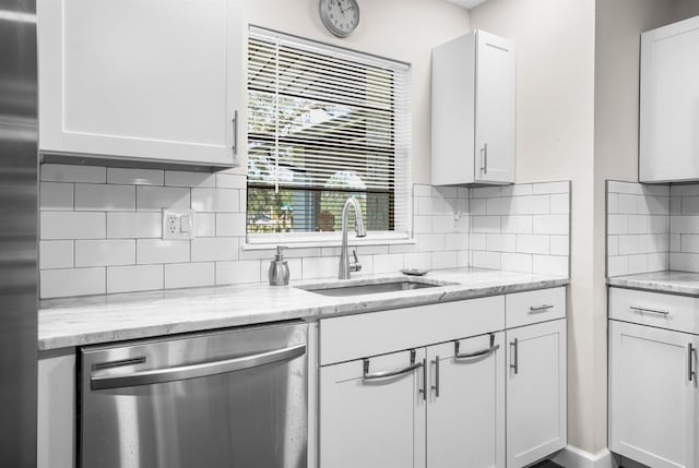 kitchen featuring white cabinetry, sink, stainless steel appliances, and tasteful backsplash