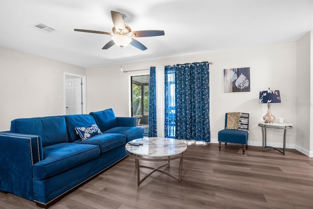 living room featuring wood-type flooring and ceiling fan