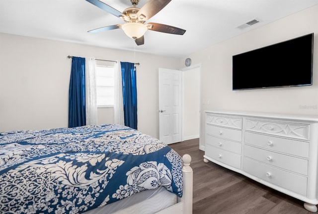 bedroom with dark hardwood / wood-style floors and ceiling fan