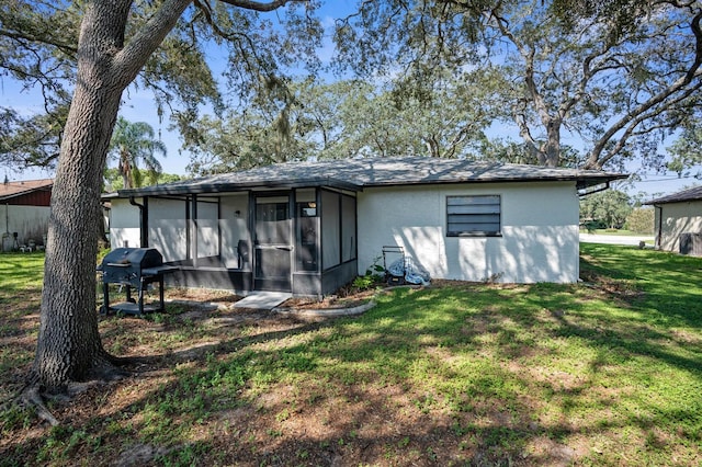 rear view of house featuring a lawn