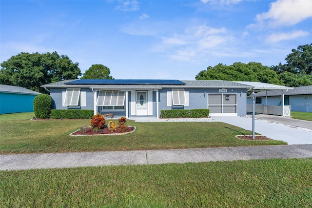 ranch-style house with solar panels, a front yard, and a carport