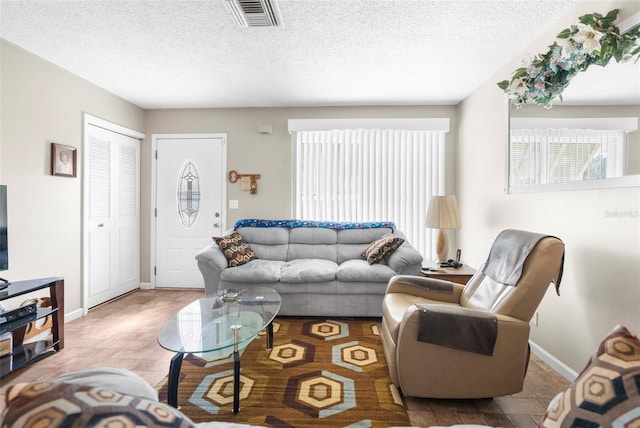 living room featuring wood-type flooring and a textured ceiling