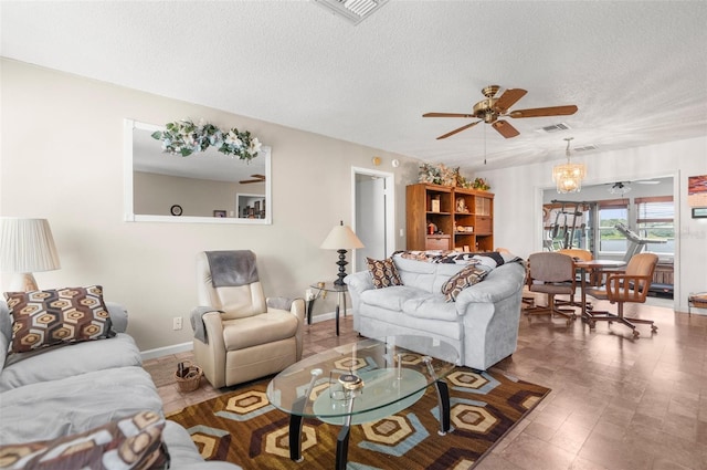 living room with a textured ceiling and ceiling fan with notable chandelier