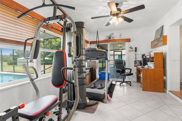 workout room featuring ceiling fan and light tile patterned floors