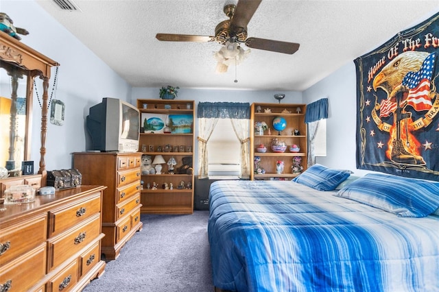 bedroom featuring ceiling fan, a textured ceiling, and dark colored carpet