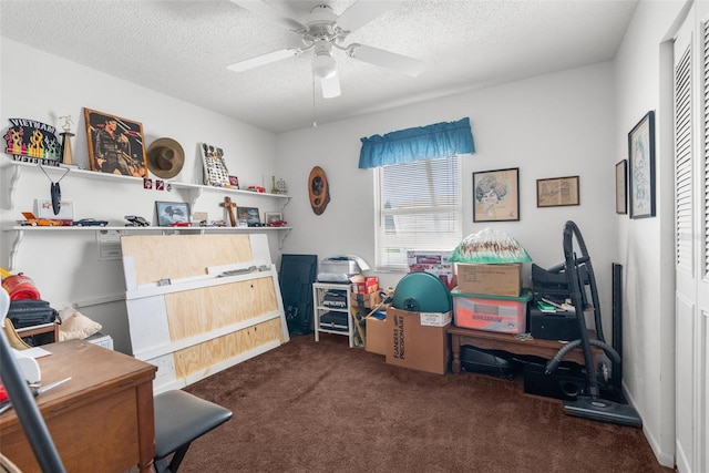 rec room with dark colored carpet, ceiling fan, and a textured ceiling