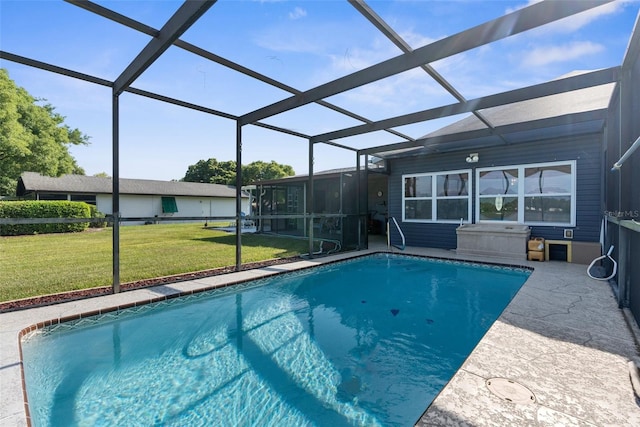 view of pool featuring glass enclosure and a lawn