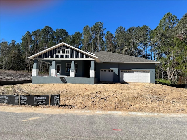 view of front of home featuring a porch and a garage